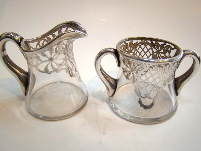 An attractive vintage silver overlay creamer & sugar made circa 1900